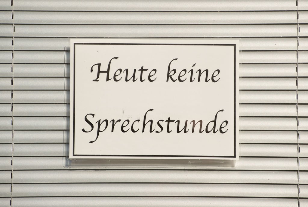 Ein Schild mit der Aufschrift "Heute keine Sprechstunde" hängt im Fenster einer Arztpraxis.