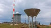 Dunkle Wolken ziehen über den Brocken und die Messinstrumente der Wetterwarte.