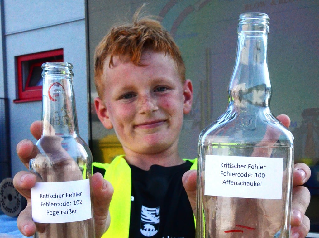 Tag der offenen Tür im Glaswerk Gardelegen, Theodor Schönewald, Junior eines Mitarbeiters, zeigt Fehlerflaschen.