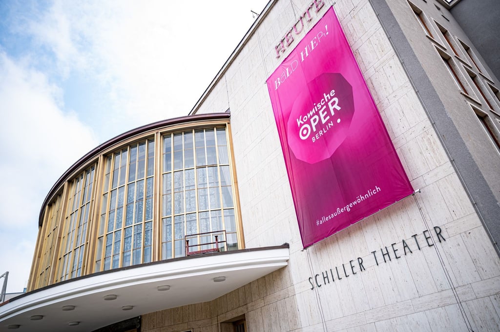 Am Gebäude des Schillertheaters hängt ein Banner der Komischen Oper Berlin.
