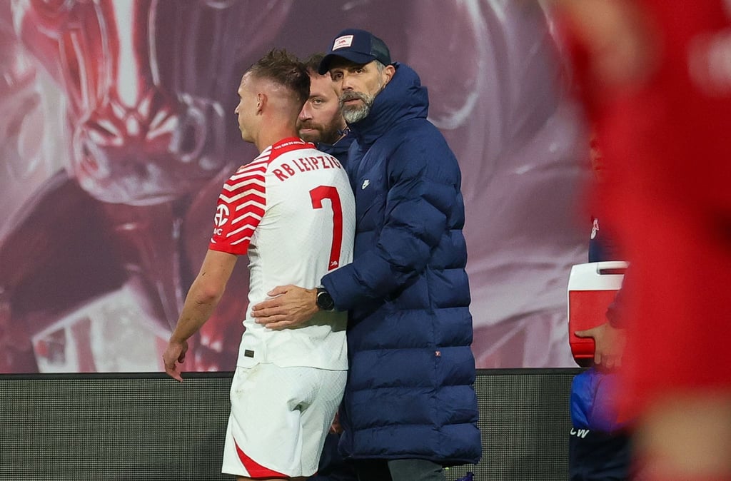Leipzigs Trainer Marco Rose (r) tröstet Dani Olmo, der verletzt vom Feld gehen muss.