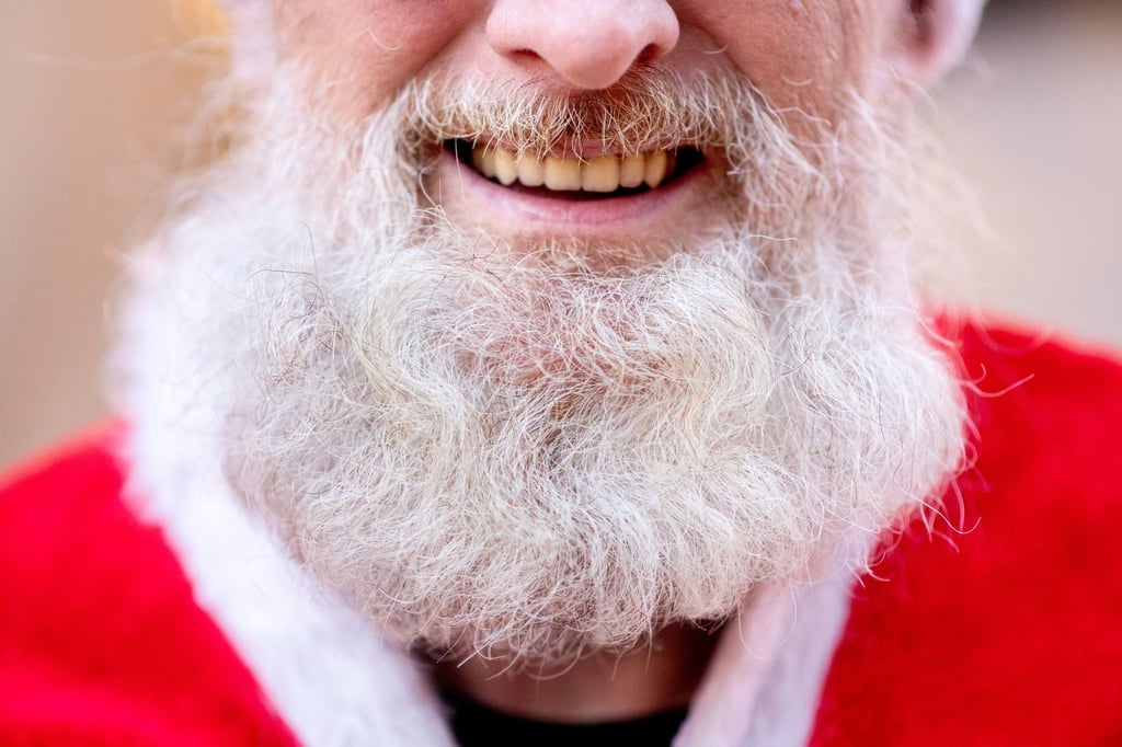 Ein Weihnachtsmann lächelt bei einer Versammlung der Weihnachtsmänner der Jobvermittlung der Agentur für Arbeit.