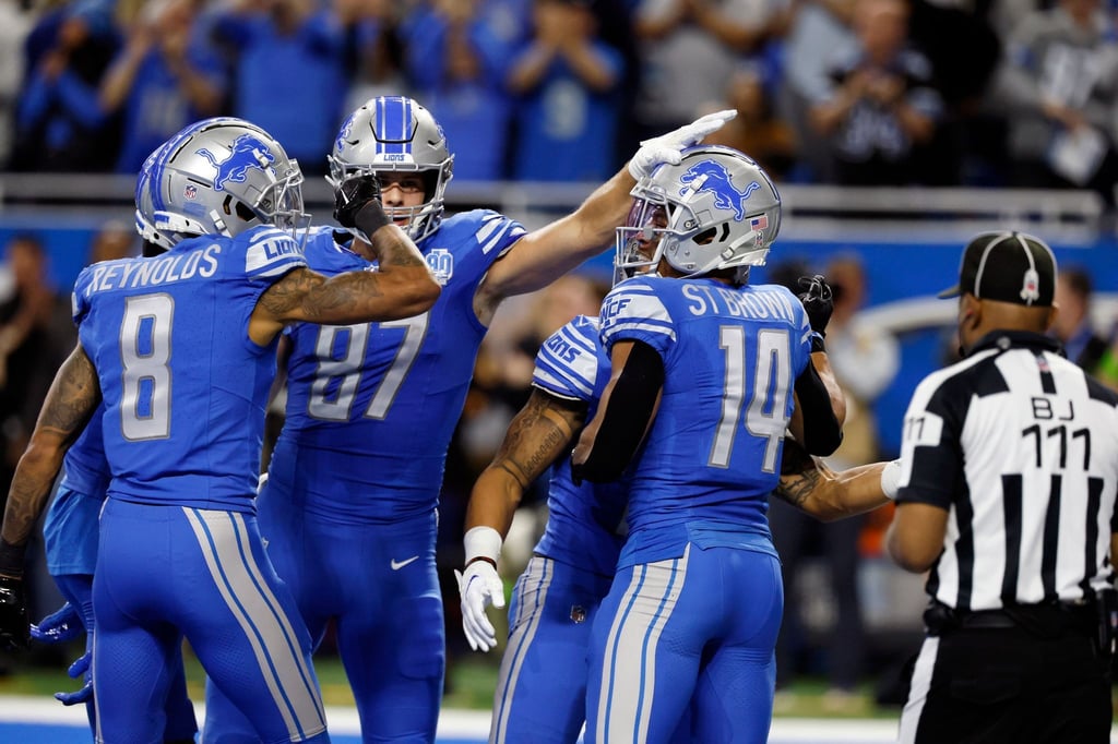 Detroits Amon-Ra St.Brown (r) jubelt mit seinen Mitspielern, nachdem er einen Touchdown erzielt hat.