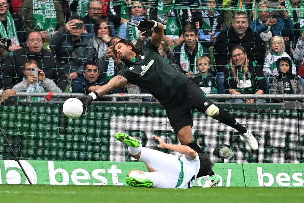 Torhüter Tim Wiese (hinten) vom Team Werder Bremen pariert einen Schuss.