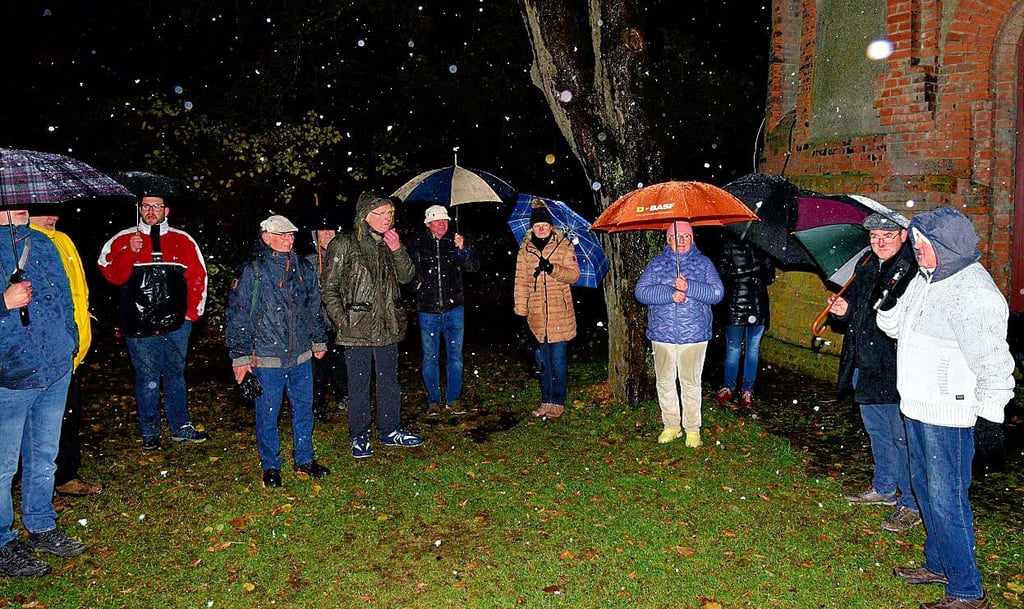 Bei Temperaturen um den Gefrierpunkt und Schneetreiben begrüßte Roland Kloß (rechts) am Freitagabend die Teilnehmer der Mondscheinwanderung am Nienburger Wasserturm.