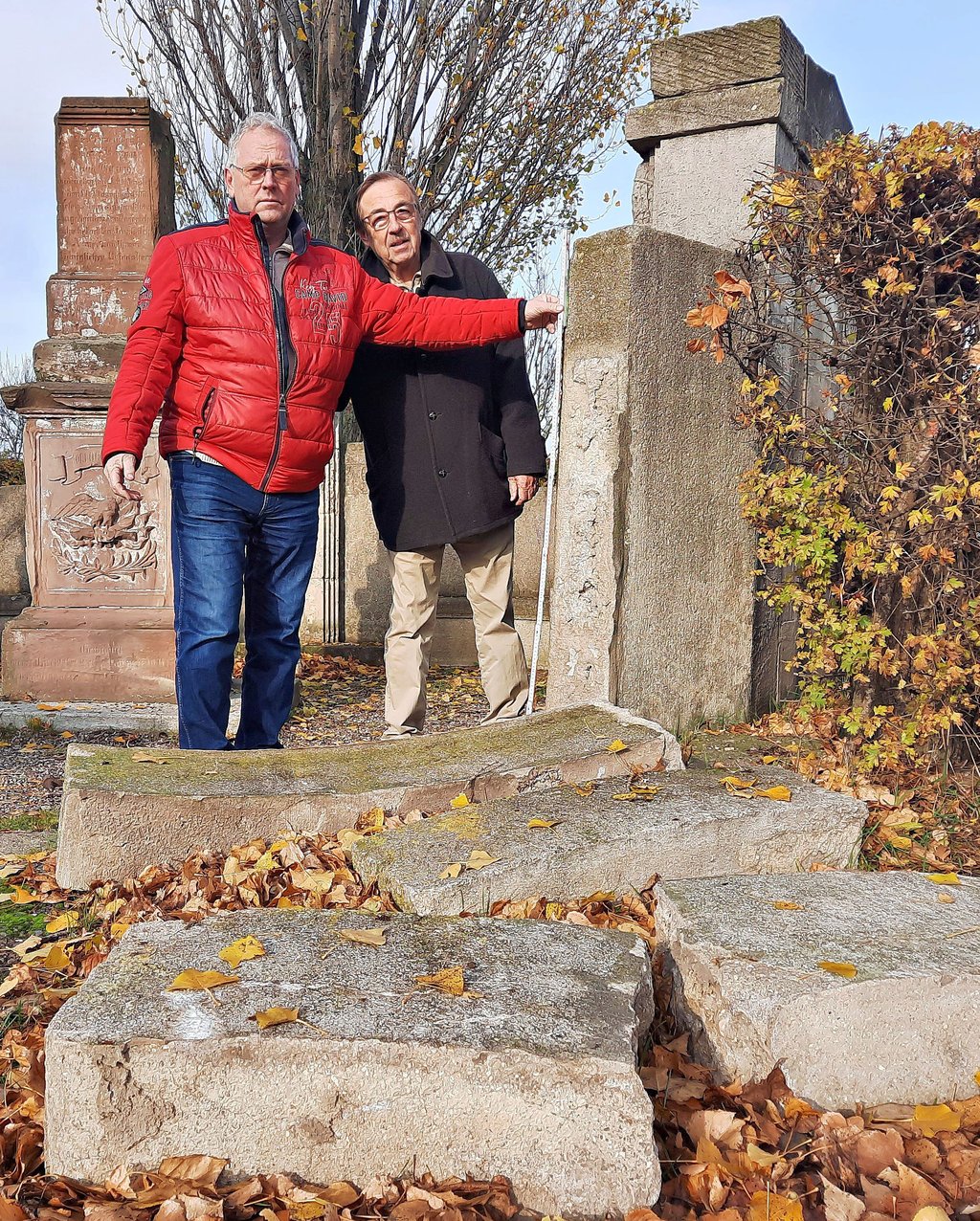 Ortsbürgermeister Jürgen Denzin (links) und Ortschaftsratsmitglied Rüdiger Kleinschmidt beklagen, dass das Borauer Kriegerdenkmal verfällt, die Mauer im Vordergrund eingestürzt ist und sich niemand dafür zuständig fühlt.