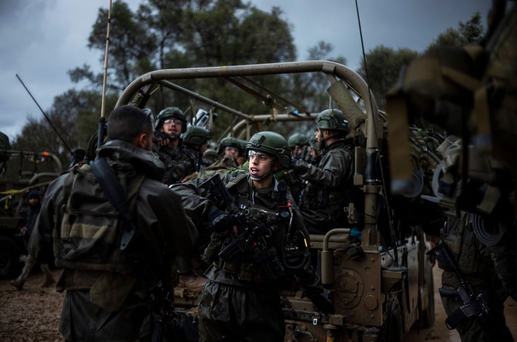 Israelische Soldaten sitzen in einem Militärfahrzeug an einem Sammlepunkt nahe der Grenze zum Gazastreifen.