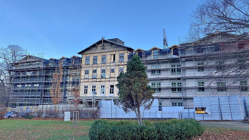 Blick vom Park auf das Bestandsgebäude mit seinen neuen Seitenflügeln.