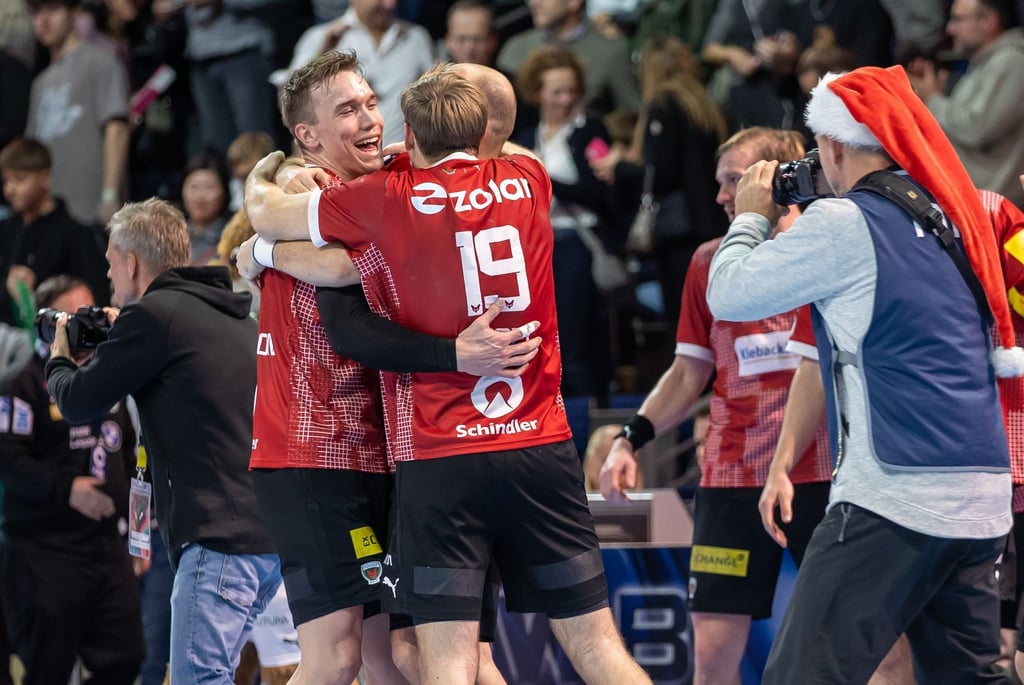 Berlins Lasse Andersson (l) und Mathias Gidsel jubeln nach dem Sieg.