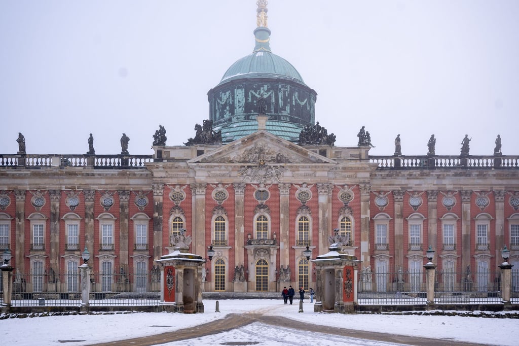 Schnee liegt bei winterlichem Wetter im Ehrenhof des Neuen Palais im Park Sanssouci.
