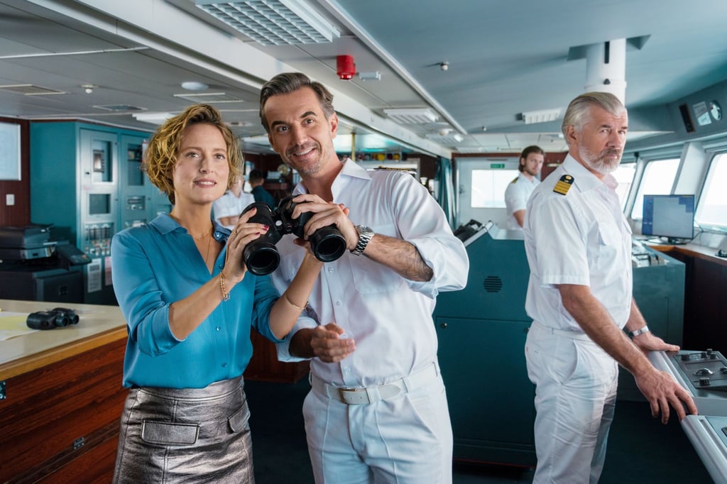 Kapitän Max Parger (Florian Silbereisen, M.) bringt zur Überraschung seines Staff-Kapitäns Martin Grimm (Daniel Morgenroth, r.) Veronika Bruckner (Wanda Perdelwitz) mit an Bord.