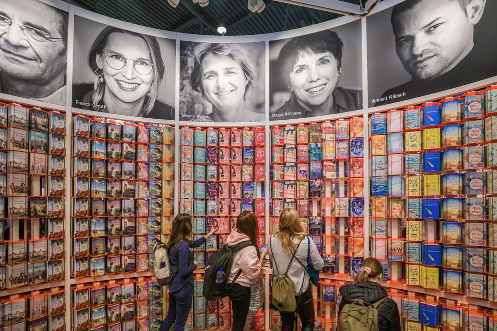 Messegäste stehen am Stand von Droemer Knaur auf der Leipziger Buchmesse.
