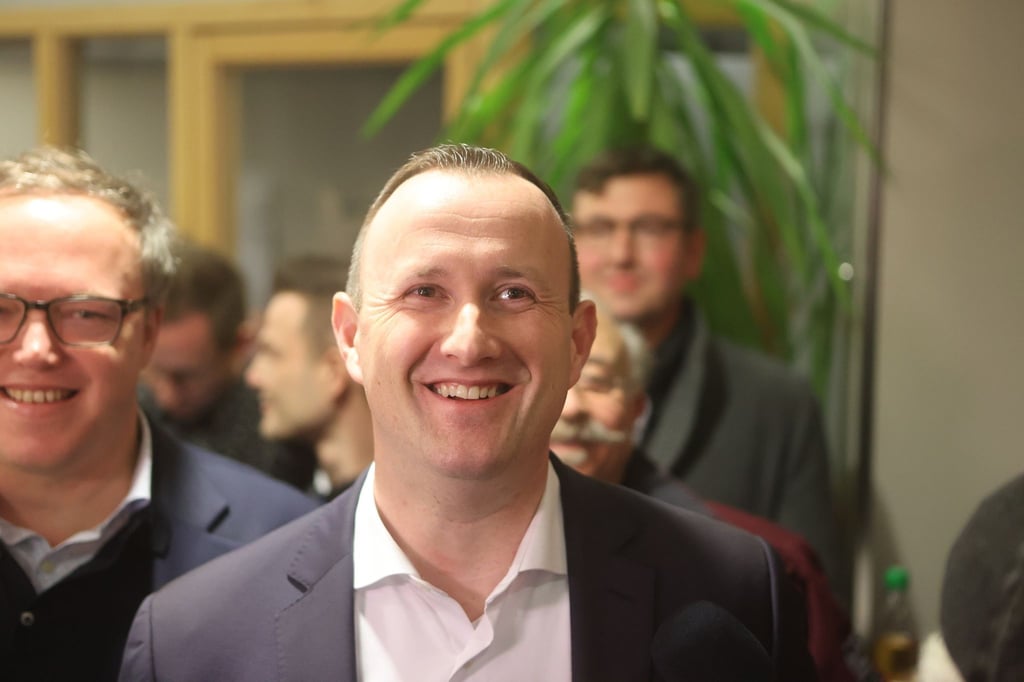 Christian Herrgott, neuer Landrat im Saale-Orla-Kreis, steht lächelnd im Landratsamt.