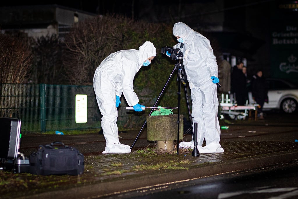 Mitarbeiter des Kriminaldauerdienst (KDD) der Polizei Hannover sichern auf einem Gehweg im Stadtteil Döhren Spuren.