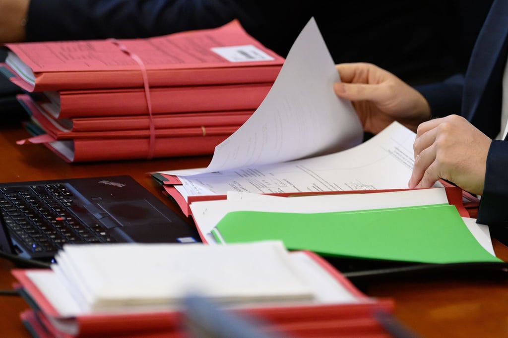 Akten liegen zum Prozessauftakt im Landgericht auf einem Tisch.