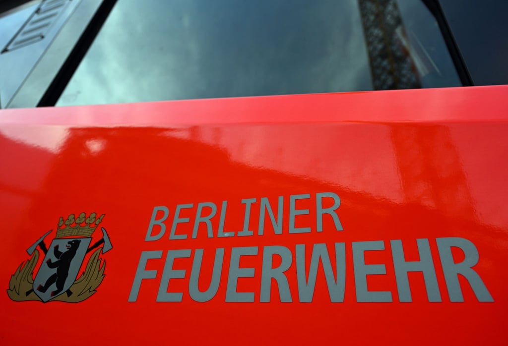Der Schriftzug „Berliner Feuerwehr“ und das Wappen Berliner Feuerwehr stehen auf der Tür eines Feuerwehrfahrzeuges.