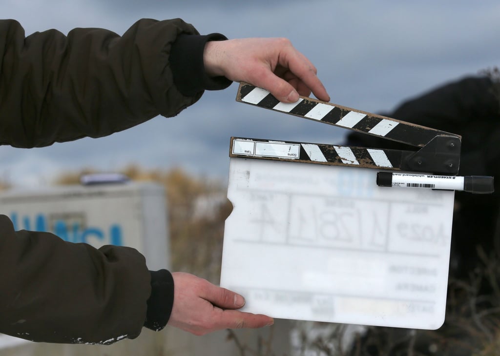 Ein Film-Team-Mitarbeiter hält eine Filmklappe.