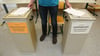 Ein Wahlhelfer steht in einem Wahllokal in Halberstadt neben den Urnen für die Oberbürgermeister- (l) und die Landratswahl.