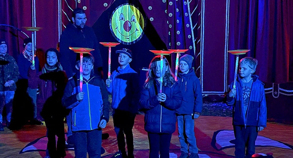 Circus Smiley ist in Lüderitz zu Gast. Hier wird mit beleuchteten Stäben die Tellerjonglage geübt.