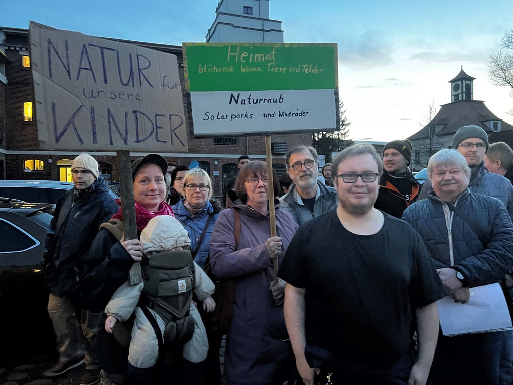 Die Unzufriedenheit steigt: Gut hundert Bürger finden sich vor der Gemeindeverwaltung ein, um gegen den geplanten Solarpark zu protestieren.