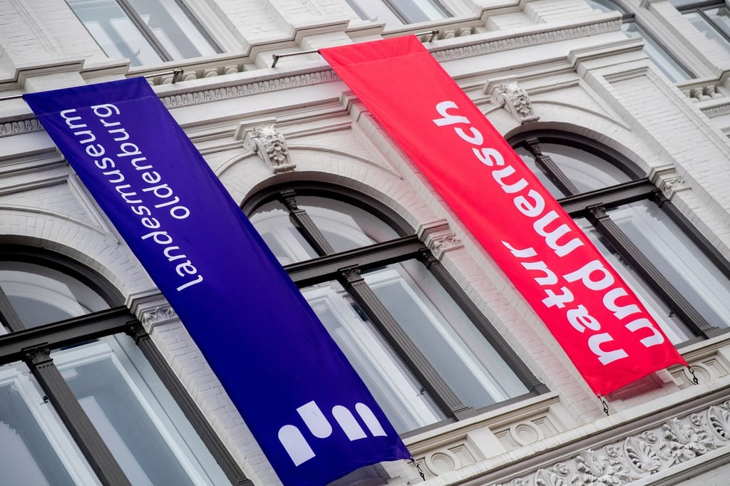 Zwei Fahnen hängen über dem Eingang zum Landesmuseum Natur und Mensch am Damm im Stadtzentrum.