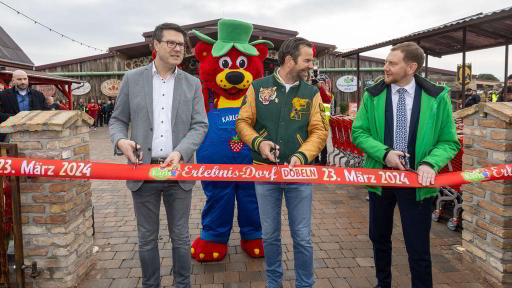 Karls Erlebnisdorf in Döbeln ist eröffnet: Döbelns Oberbürgermeister Sven Liebhauser (CDU), "Karls"-Chef Robert Dahl und Sachsens Ministerpräsident Michael Kretschmer (v.l.) schneiden das obligatorische Band durch.