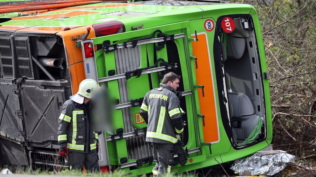 Ein Reisebus liegt zur Seite gekippt an der Unfallstelle auf der A9. Bei einem Unfall mit einem Reisebus auf der A9 nahe Leipzig sind mindestens fünf Menschen ums Leben gekommen.