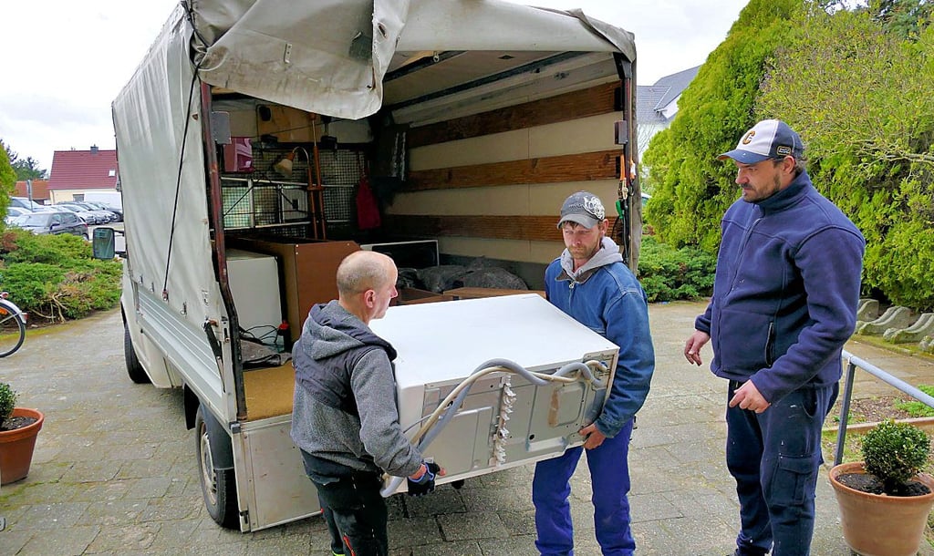 Am Vortag haben die Mitarbeiter des „Wir“-Vereins noch Wände gestrichen, jetzt tragen sie wieder neue Möbelspenden ins Haus.