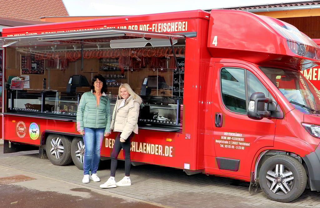 Ina Messner und Pia Pietrzak (v. li.), Mitarbeiterinnen „Der Ferchländer“ vor den neuen modernen Verkaufsmobilen, die in der Altmark, im Jerichower Land und sogar in Brandenburg unterwegs sind.