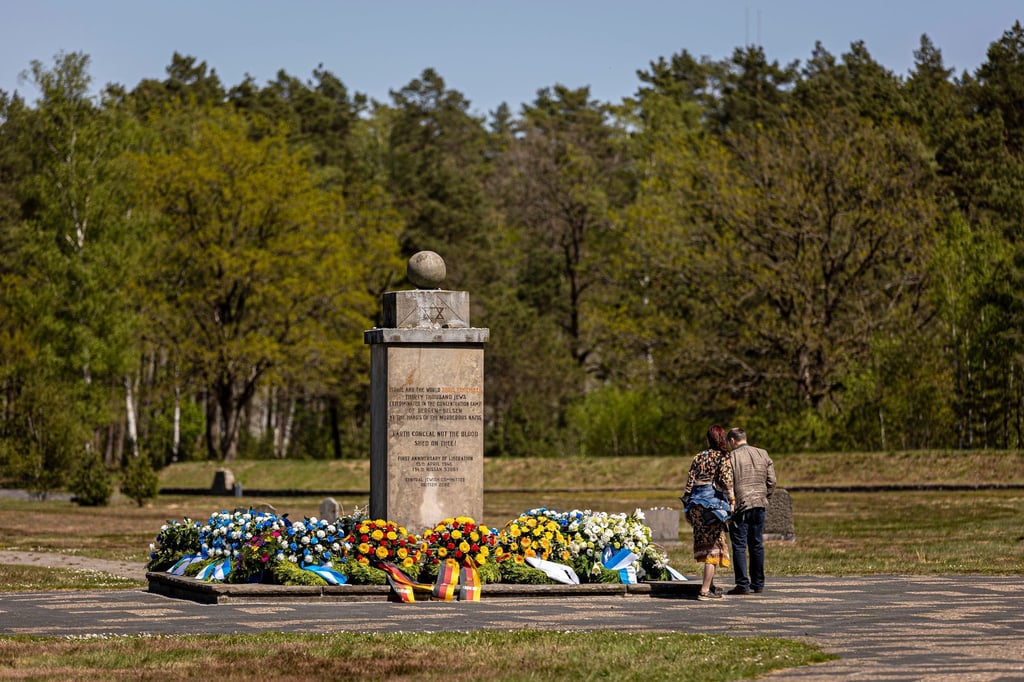 Zahlreiche Blumenkränze liegen um einen Gedenkstein auf dem Gelände der Gedenkstätte Bergen-Belsen.