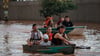 Mitglieder eines Rettungsteams bei der Evakuierung von Menschen, die von einer Überschwemmung betroffen sind.