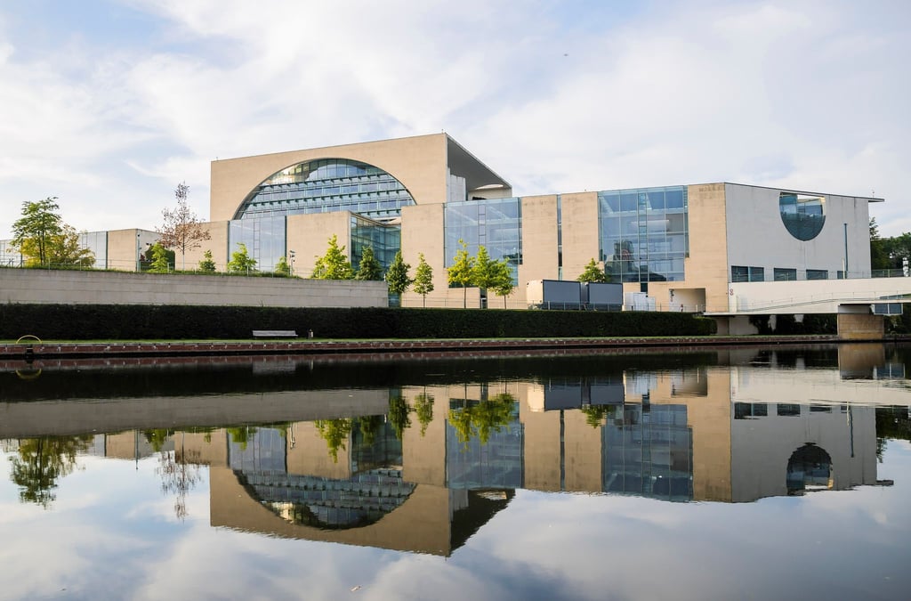 Das Bundeskanzleramt spiegelt sich in der Spree.