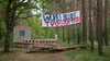 „Wuhli bleibt“ steht auf einem Transparent an einem Waldstück in der Wuhlheide.