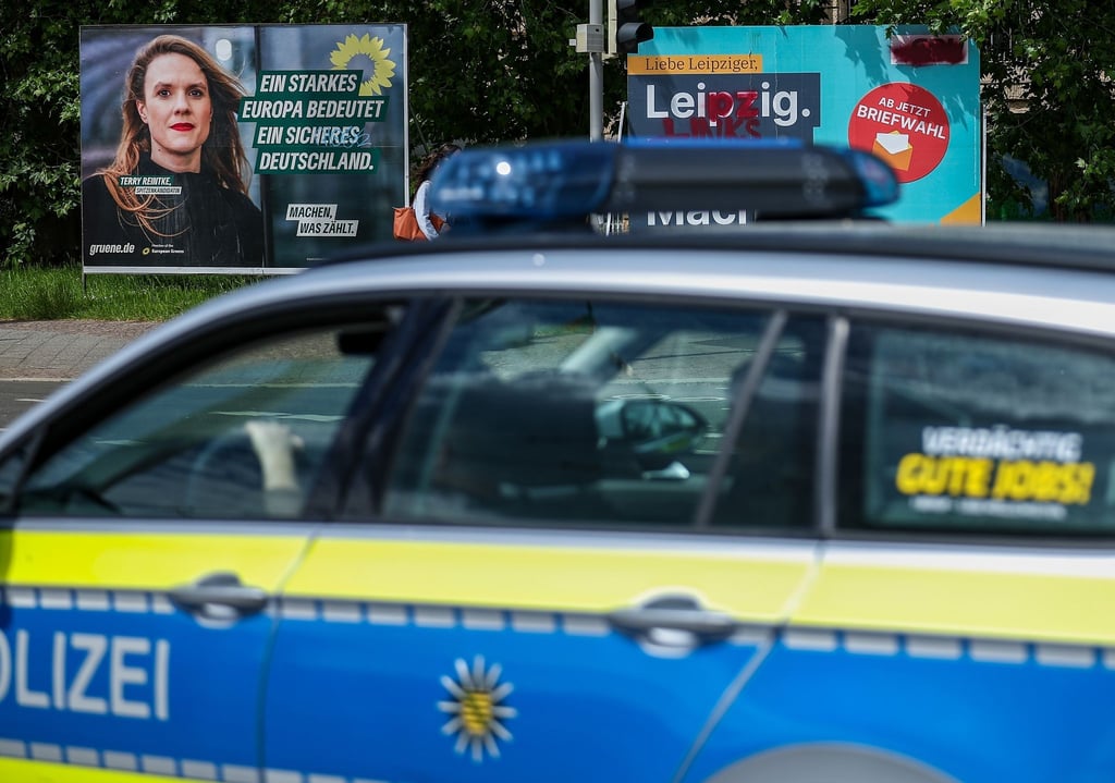 Ein Streifenwagen der sächsischen Polizei fährt an Wahlplakaten von Grünen (l-r), CDU und SPD vorbei.