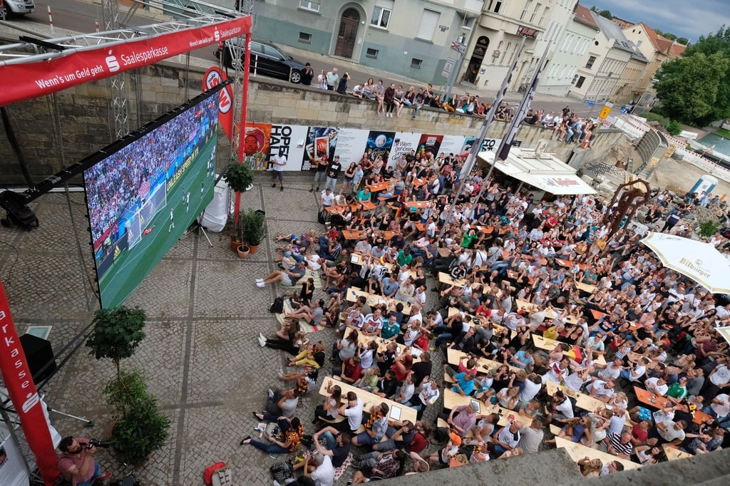 Teilnehmer eines Public Viewings verfolgen 2018 vor der Oper in Halle die Begegnung Deutschland-Mexiko bei der Fußball-Weltmeisterschaft in Russland.