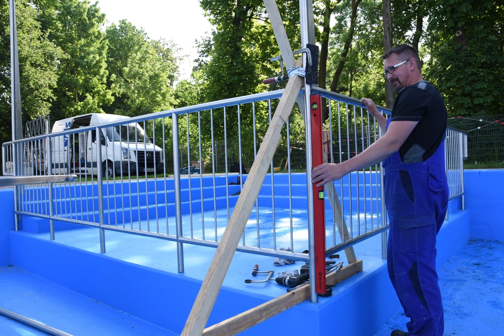 Karsten Wesche, Mitarbeiter einer Gardelegener Metallbaufirma, beim Einbau des Geländers im neuen Babybecken des Freibades Kalbe.
