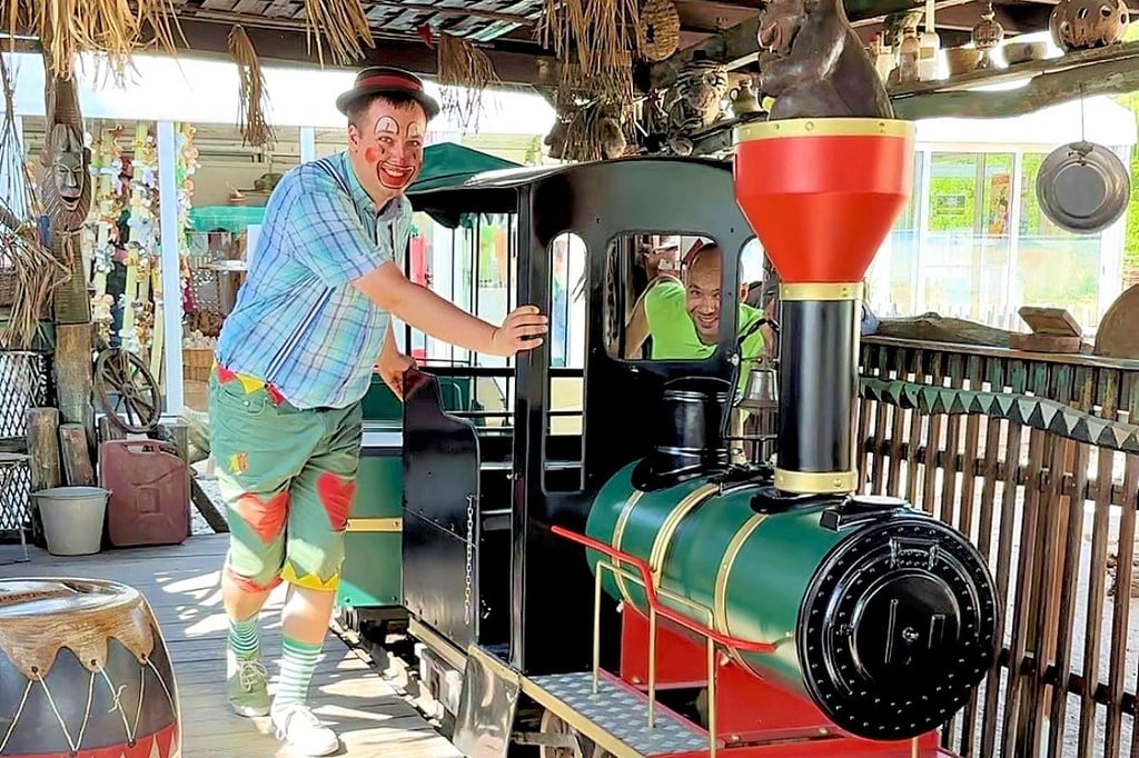 Clown Hopsi half den Mitarbeitern, die Kindereisenbahn zurück ins Depot zu schieben.