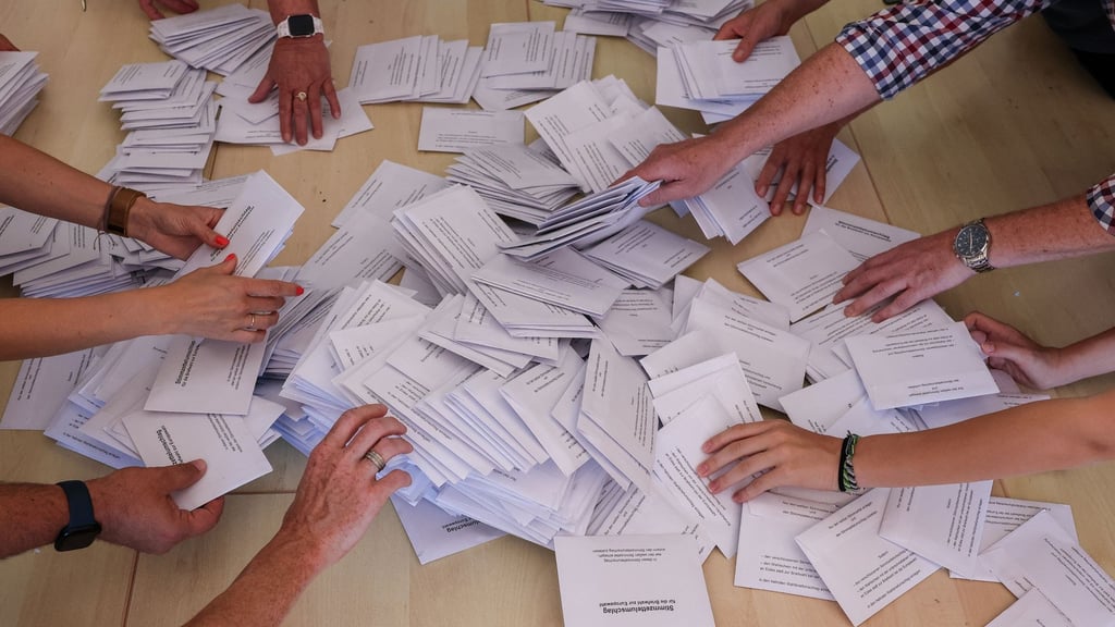 Zahlreiche Wahlhelfer nehmen sich bei der Stimmenauszählung die Umschläge mit den Briefwahlstimmen zur Europawahl.