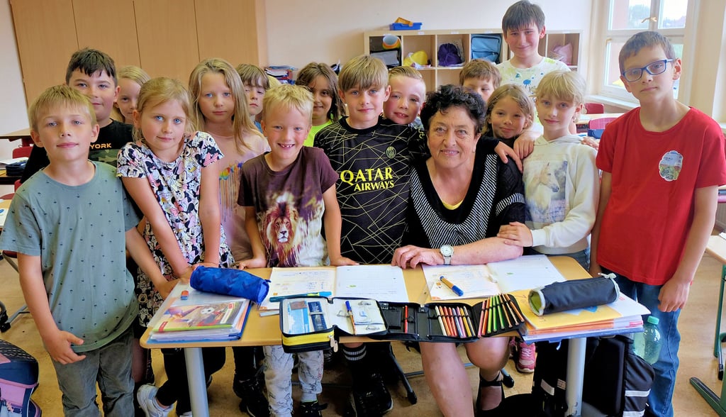 Die Mädchen und Jungen der zweiten Klasse stellen sich mit Ingrid Mehlhorn noch für ein Abschiedsfoto auf.
