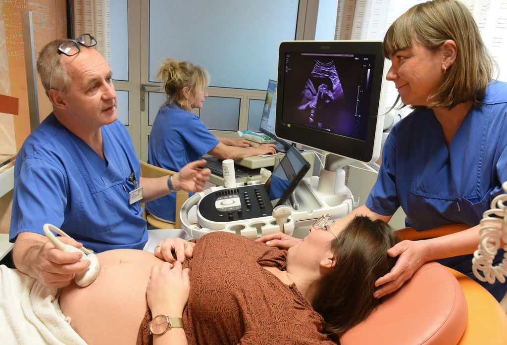 Im Krankenhaus St. Elisabeth und St. Barbara bespricht Dr. Sven Seeger, Chefarzt der Klinik für Geburtshilfe, im Ultraschallraum vom Kreißsaalbereich mit der Leitenden Hebamme Kathrin Eichhorn (r) und Hebamme Manuela (2.v.r) die Möglichkeiten der Entbindung nach einem Ultraschall bei einer Schwangeren.
