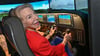 US-Botschafterin Amy Gutmann testet die Newton Flight Academy und sitzt am Simulator.
