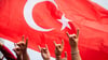Türkei-Fans zeigen beim Fanmarsch Richtung Olympiastadion den „Wolfsgruß“.