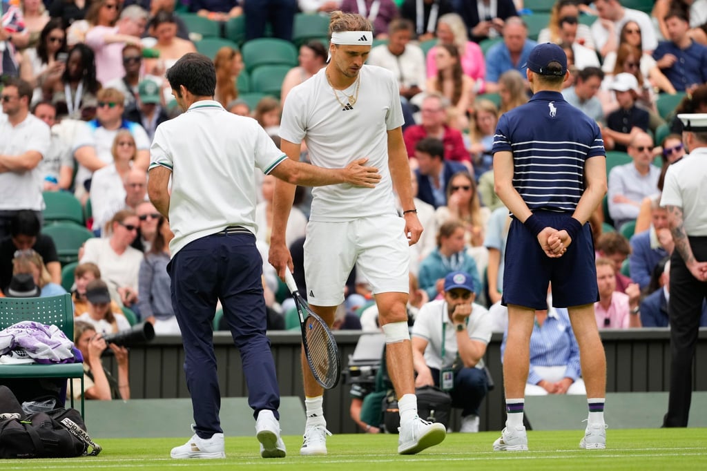 Alexander Zverev (r) geht zurück auf den Platz, nachdem ihm nach seinem Sturz ein Verband um sein Knie gewickelt worden ist.