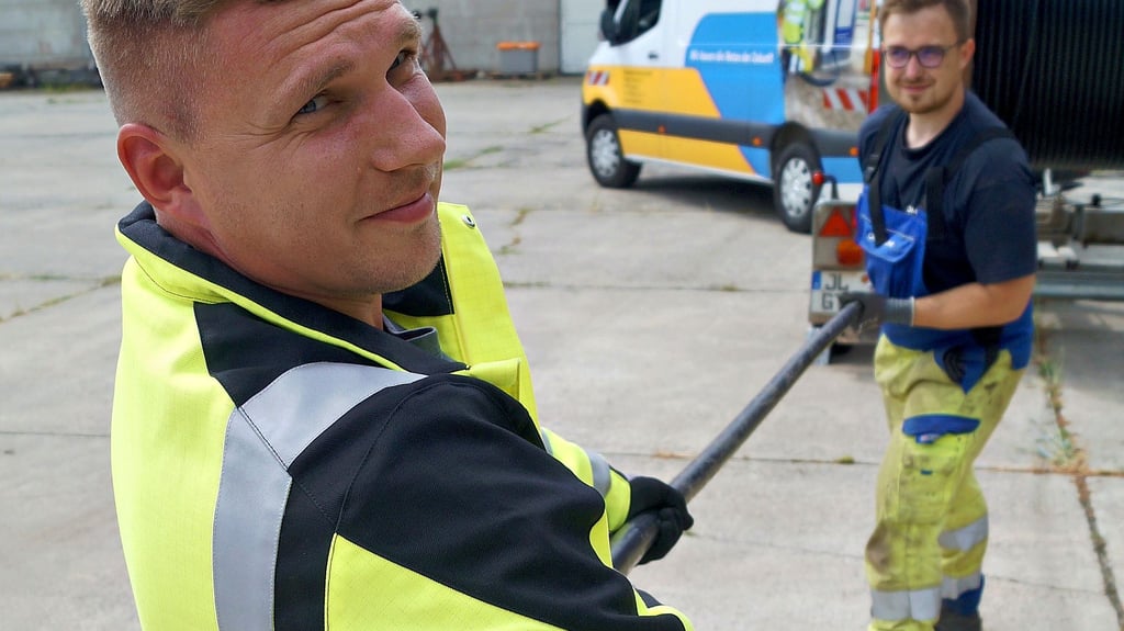 Martin Wöhe (vorn) und Niklas Schmidt rollen ein Kabel von der Trommel.