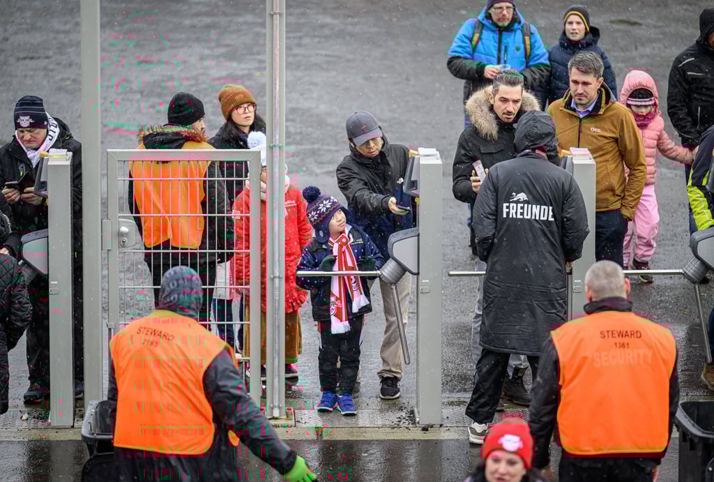 Fans scannen beim Einlass ins RB-Stadion ihre Tickets.