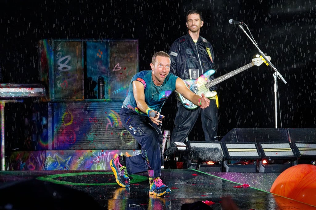 Bei starkem Regen beginnt Coldplay die Performance in Düsseldorf.