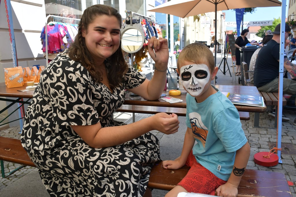 Der sechsjährige Jaden aus Haldensleben lässt sich von Hana Denecke am Stand der Hebammenpraxis Zwergenland als gruseliges Skelett schminken.
