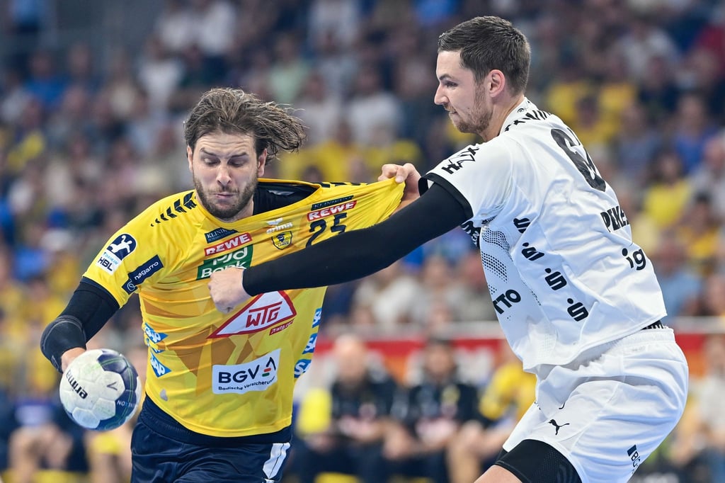 Kiels Hendrik Pekeler (r) langt gegen den Mannheimer Olle Forsell Schefvert zu.