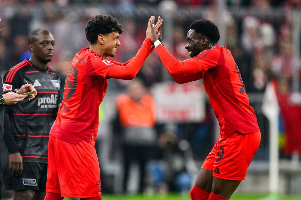 Der große Moment für Adam Aznou (l): Der 18 Jahre alte Debütant wird für Alphonso Davies (r) eingewechselt, der sich mit ihm freut.