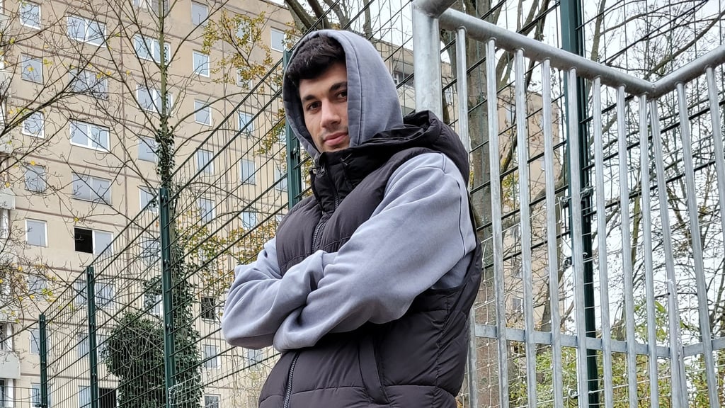 Burim Halili posiert auf dem Bolzplatz in Halle-Neustadt, auf dem er zum ersten Mal in seinem Leben gegen den Ball trat.
